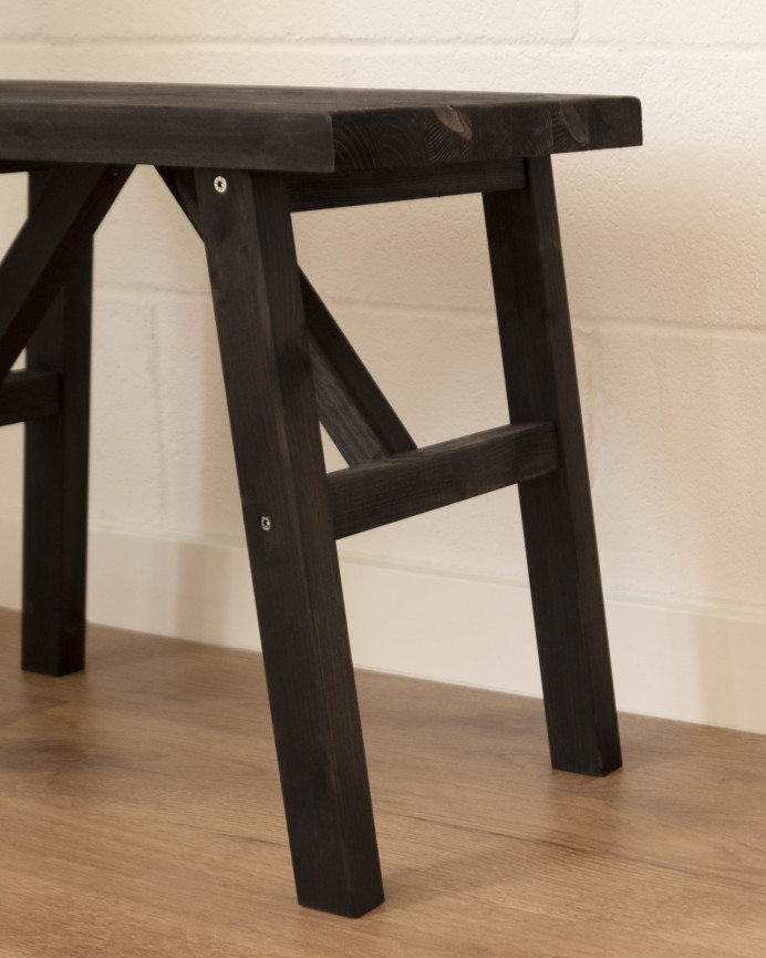 Massiver Hocker aus schwarzem Holz in den Maßen 45x55cm.