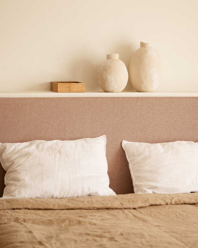 Upholstered headboard in smooth polyester in orange color of various sizes.
