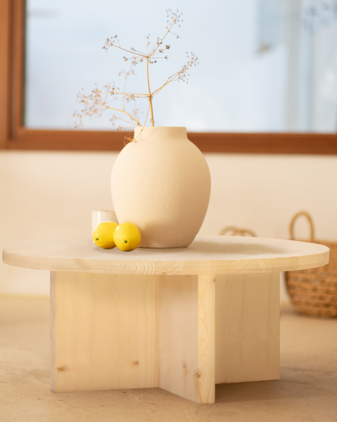 Round solid wood coffee table with natural finish available in various sizes.