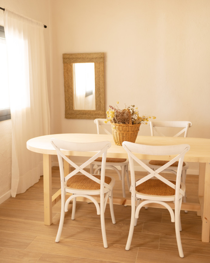 Oval solid wood dining table in natural tone available in various sizes.