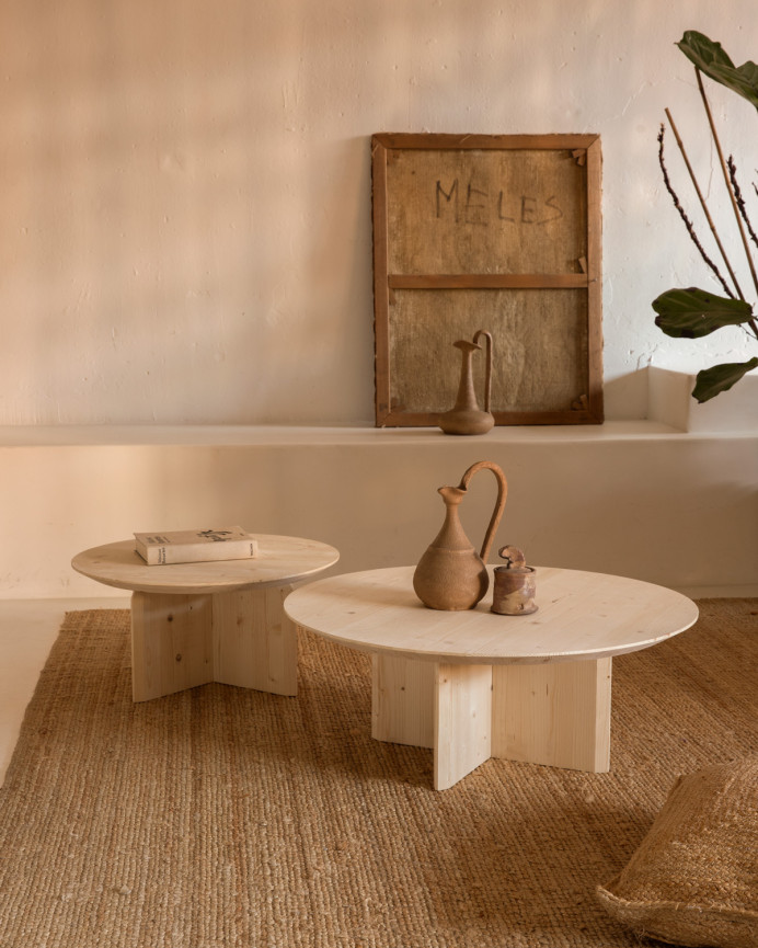 Round solid wood coffee table in natural tone available in various sizes.
