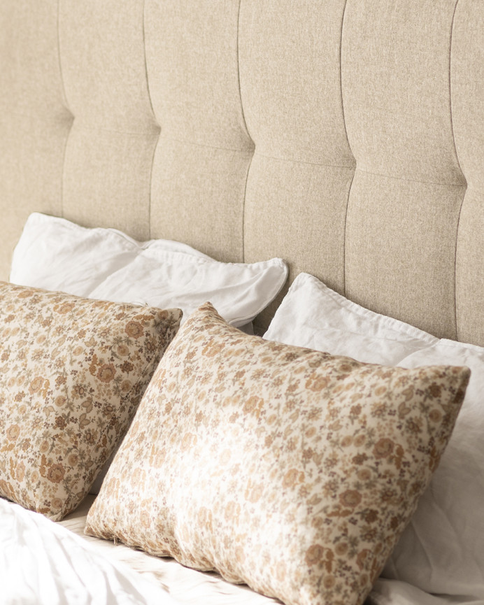 Upholstered polyester headboard with beige pleats in various sizes.