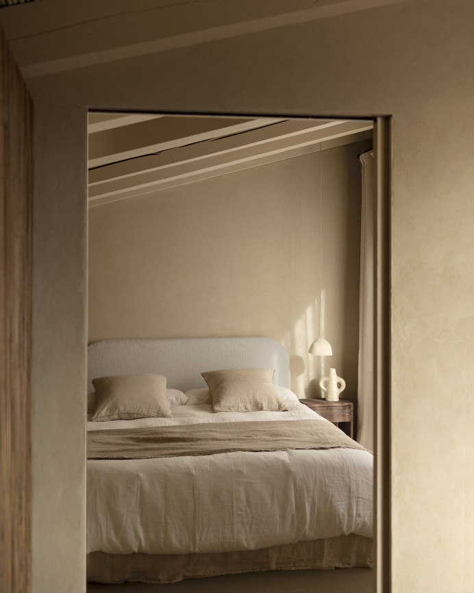 Upholstered headboard with removable light gray bouclé cover in various sizes.