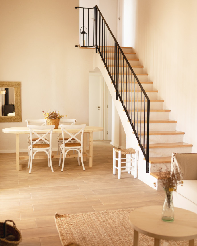Oval solid wood dining table in natural tone available in various sizes.