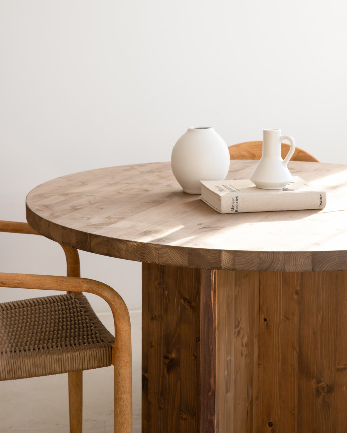 Round solid wood dining table in a dark oak tone with a diameter of 110cm.