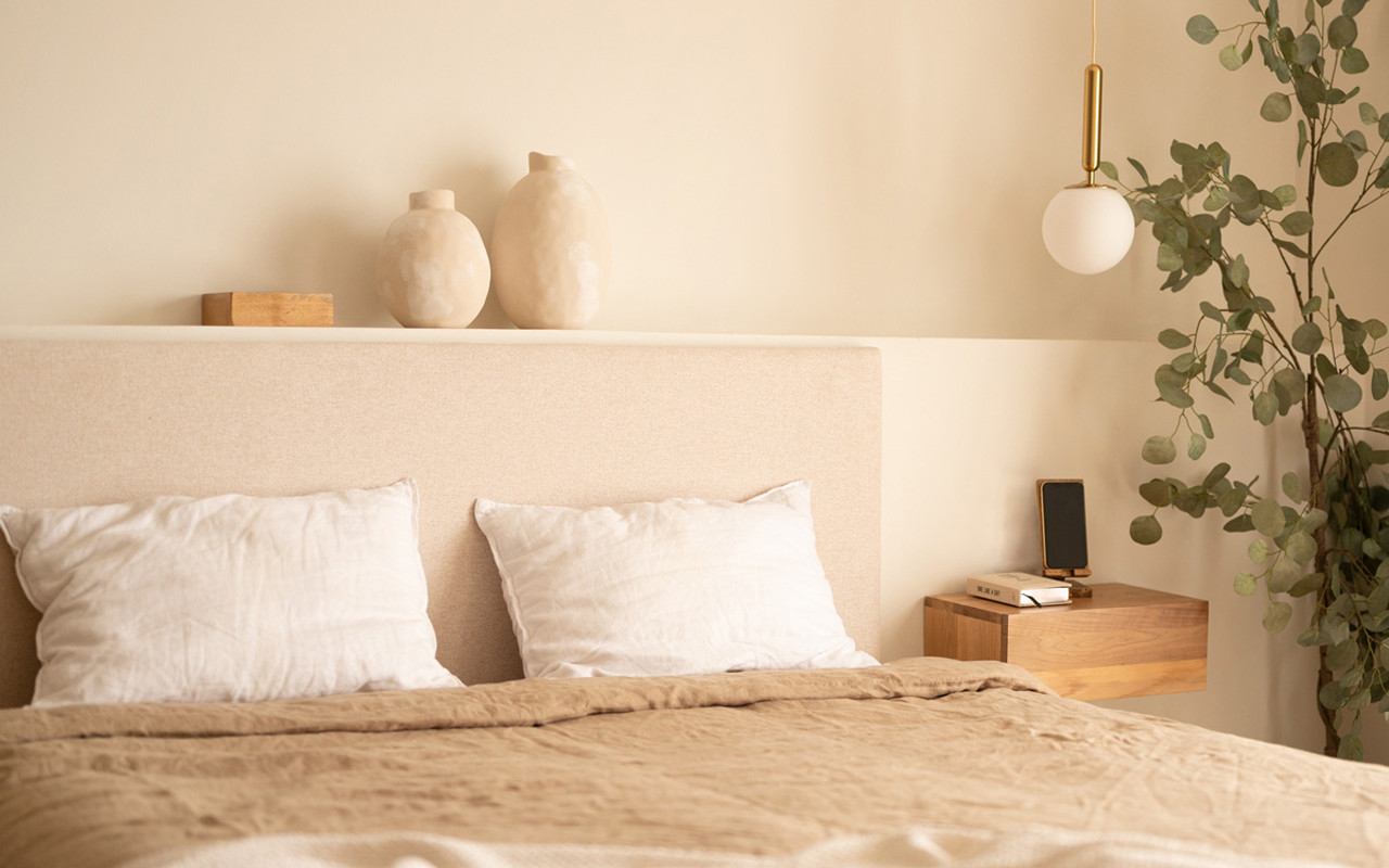 Upholstered beige headboard set and 2 dark oak solid wood floating nightstands in various sizes.