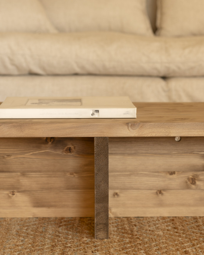 Solid wood coffee table in a dark oak tone measuring 124x27cm.
