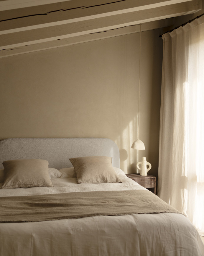 Upholstered headboard with removable light gray bouclé cover in various sizes.