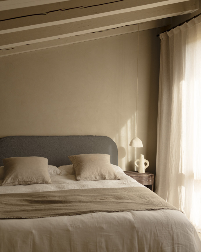 Removable dark gray bouclé upholstered headboard available in various sizes.