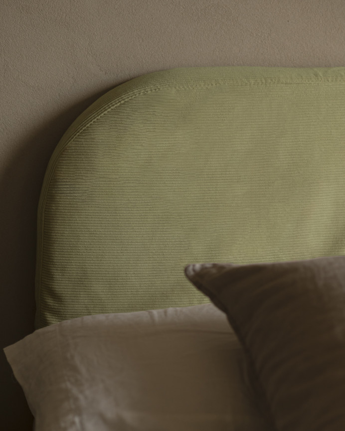 Upholstered headboard with removable lime corduroy cover in various sizes.