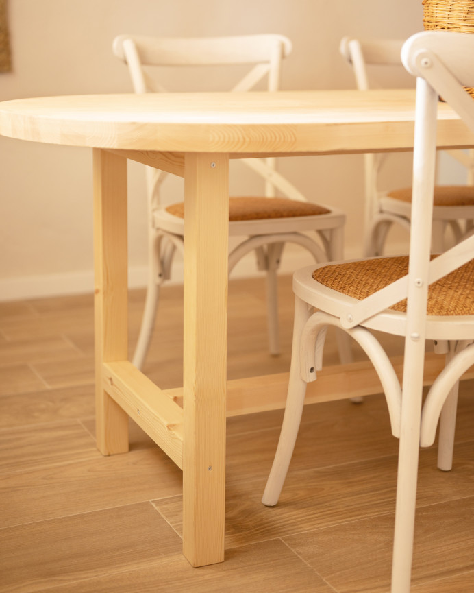 Oval solid wood dining table in natural tone available in various sizes.
