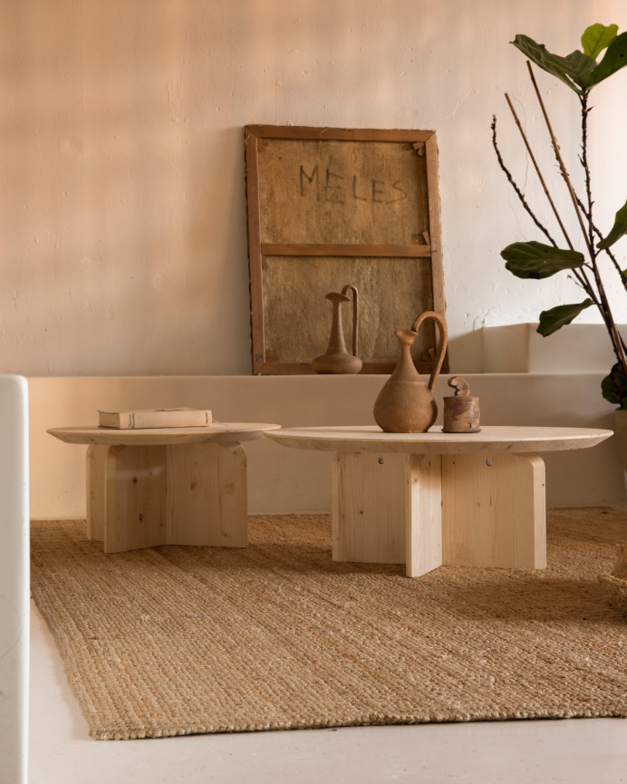 Round solid wood coffee table in natural tone available in various sizes.