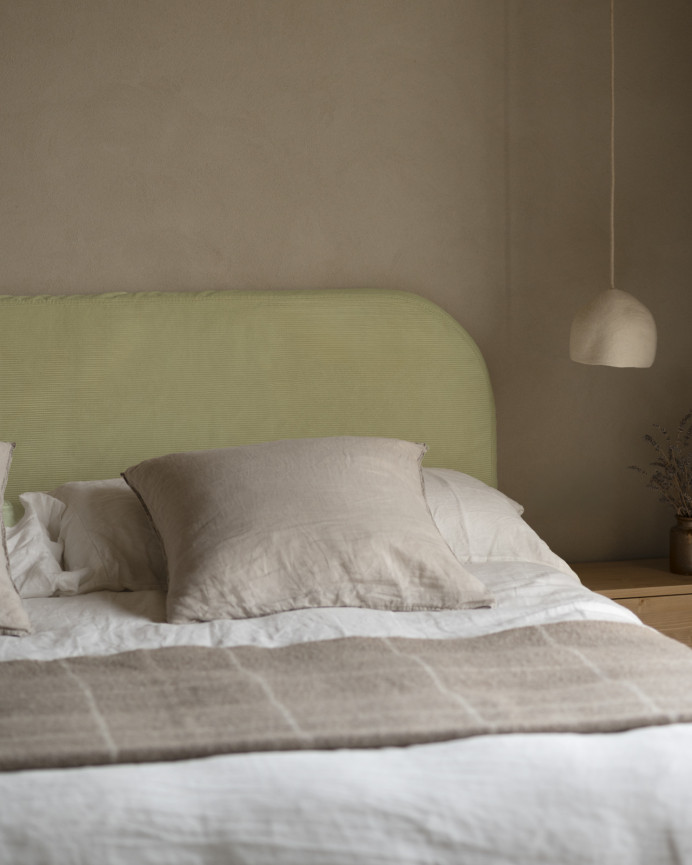 Upholstered headboard with removable lime corduroy cover in various sizes.