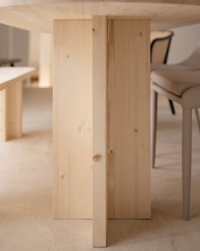 Oval solid wood dining table in natural tone available in various sizes.