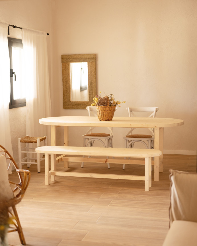 Oval solid wood dining table in natural tone available in various sizes.
