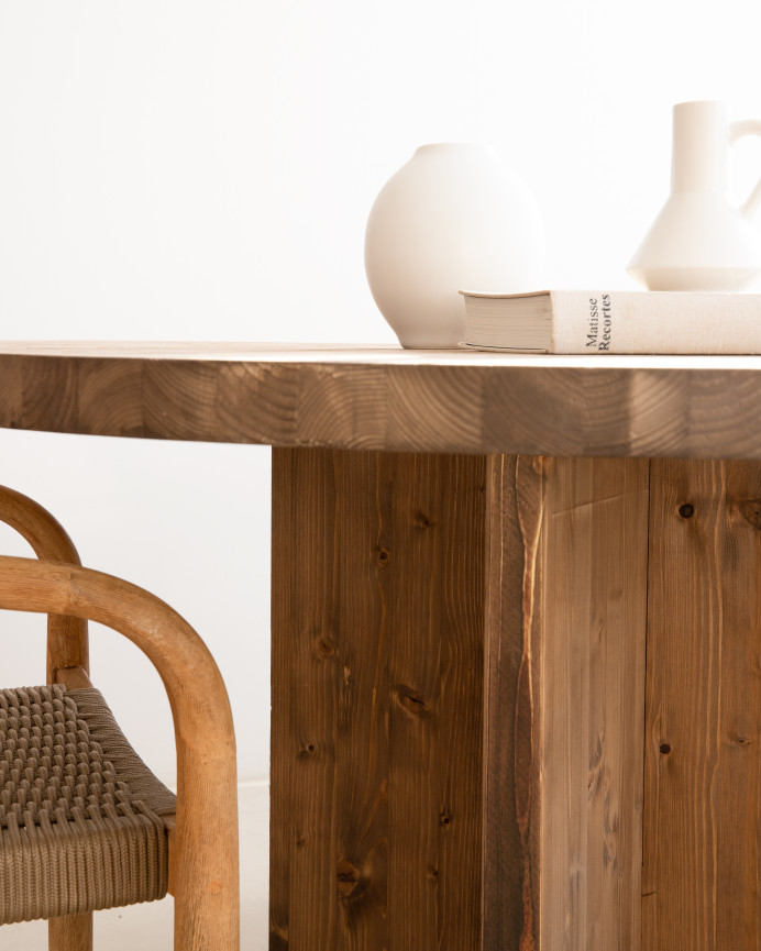Round solid wood dining table in a dark oak tone with a diameter of 110cm.