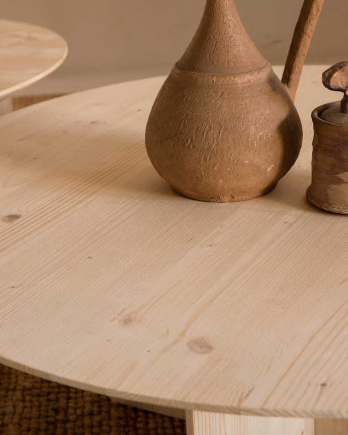 Round solid wood coffee table in natural tone available in various sizes.