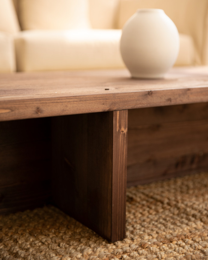 Solid wood walnut-toned coffee table measuring 124x27cm.