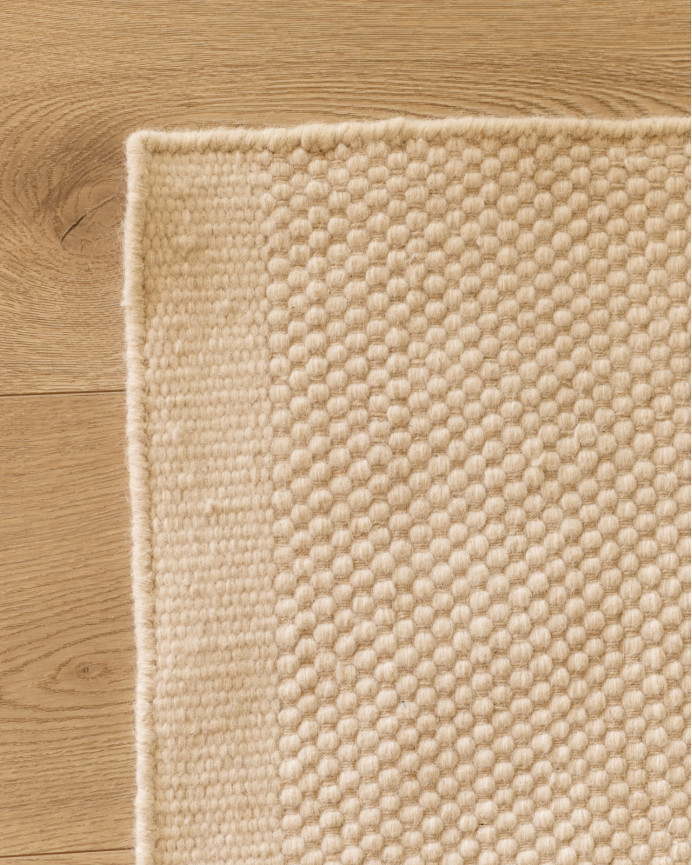White wool rug in various sizes.