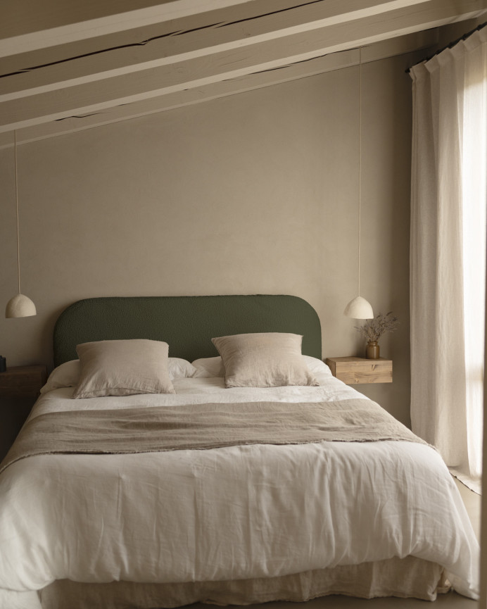 Upholstered headboard with removable cover in green bouclé fabric in various sizes.