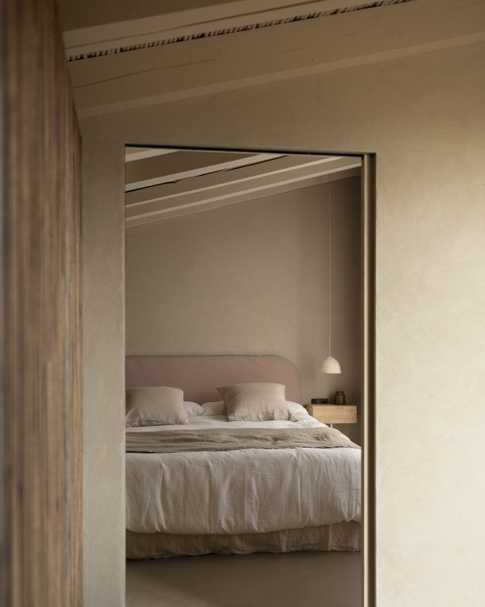 Upholstered headboard in removable pink bouclé fabric, available in various sizes.