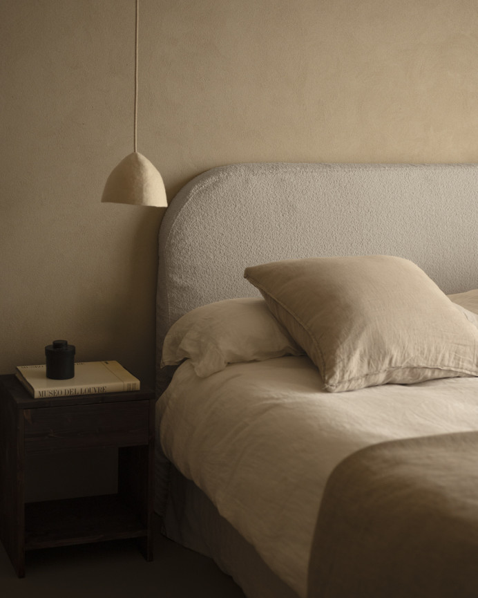 Upholstered headboard with removable light gray bouclé cover in various sizes.