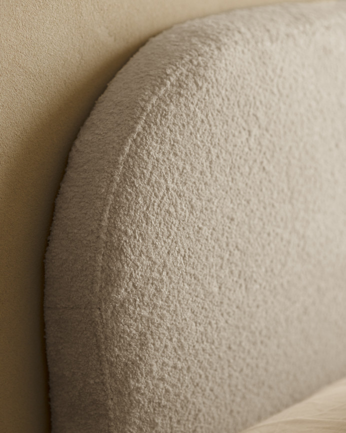 Upholstered headboard with removable light gray bouclé cover in various sizes.