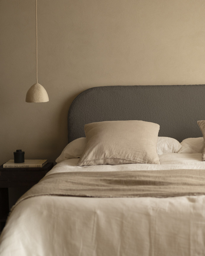 Removable dark gray bouclé upholstered headboard available in various sizes.