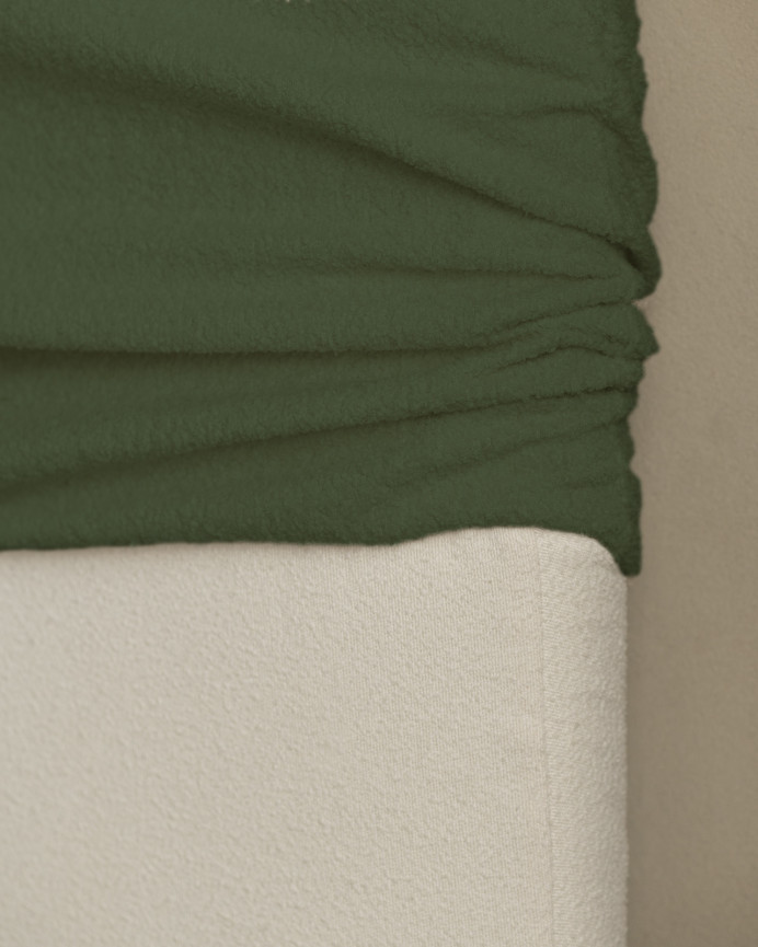 Upholstered headboard with removable cover in green bouclé fabric in various sizes.