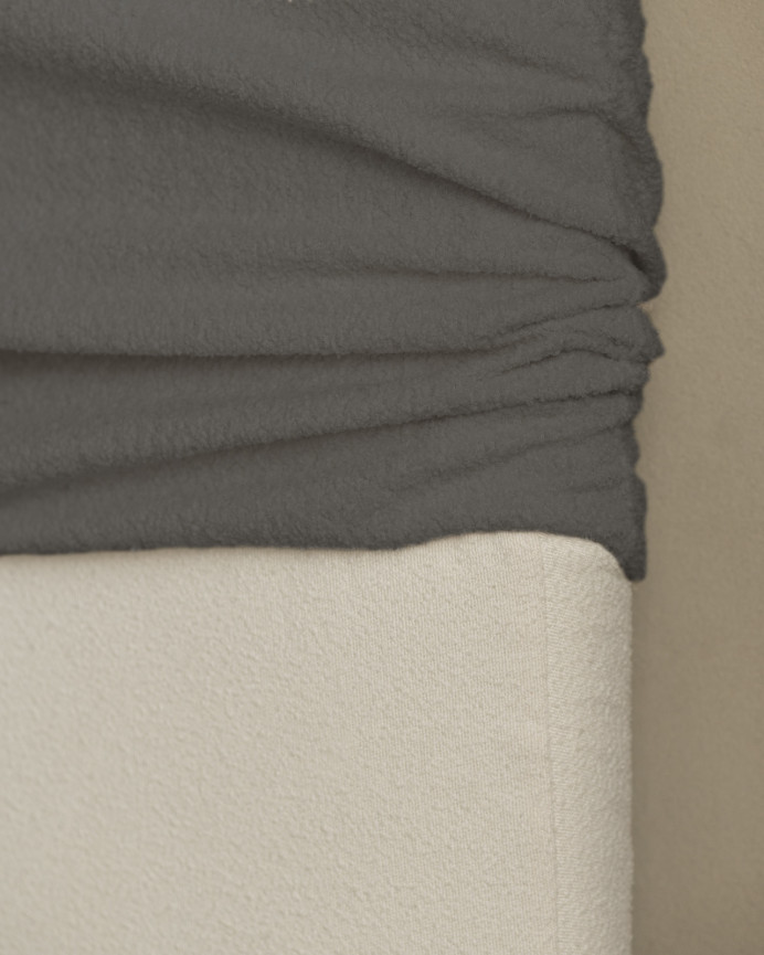 Removable dark gray bouclé upholstered headboard available in various sizes.