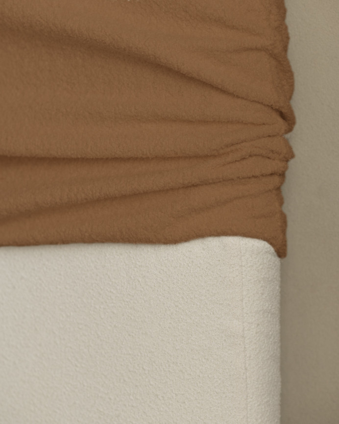 Upholstered headboard, removable cover in copper bouclé, available in various sizes.