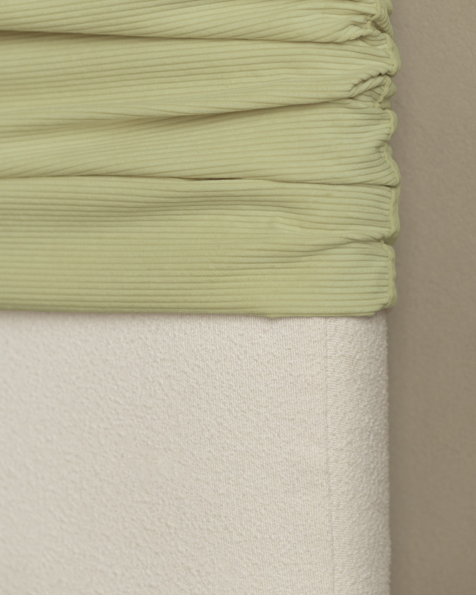 Upholstered headboard with removable lime corduroy cover in various sizes.