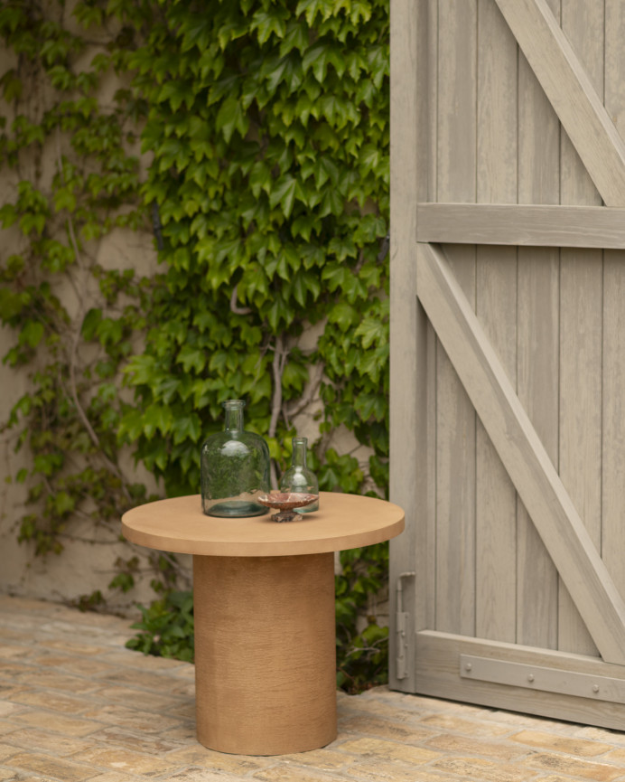 Round microcement coffee table in terracotta tone available in various sizes.