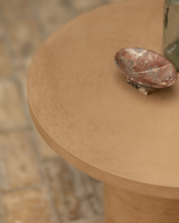 Round microcement coffee table in terracotta tone available in various sizes.