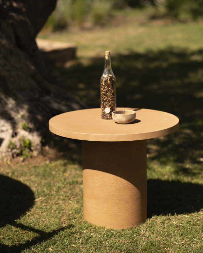 Round microcement coffee table in terracotta tone available in various sizes.