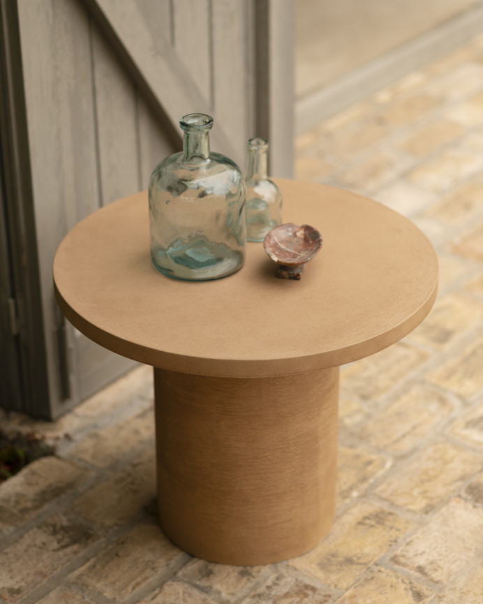 Round microcement coffee table in terracotta tone available in various sizes.