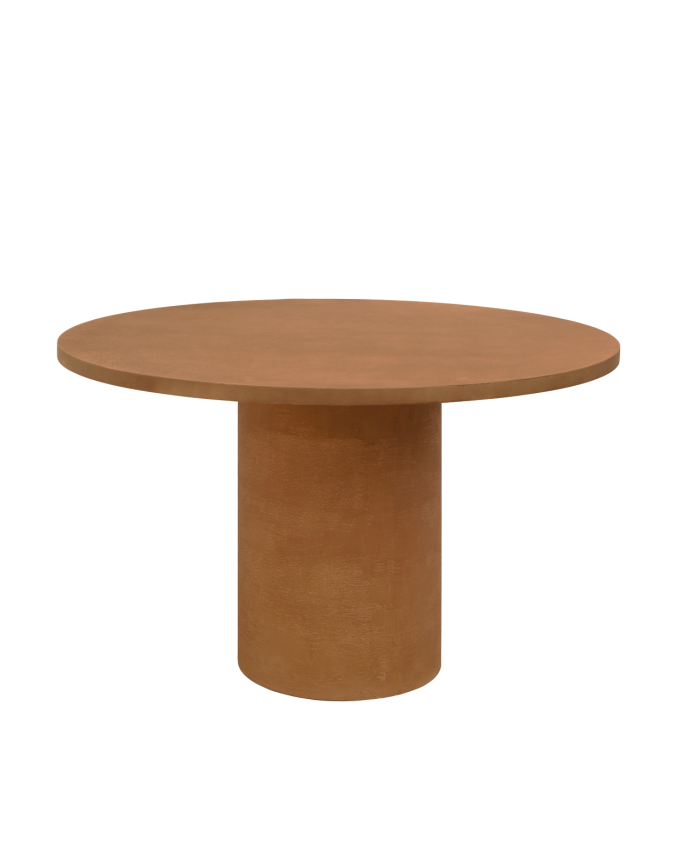 Round dining table made of terracotta-tone microcement in various sizes.