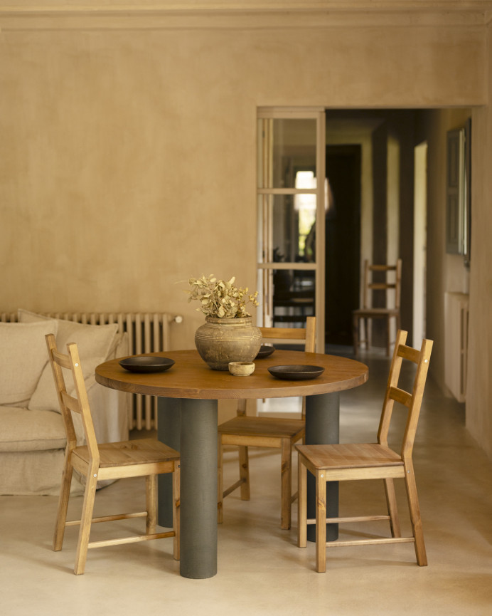 Round solid oak wood dining table with dark oak tone and microcement legs in various sizes.