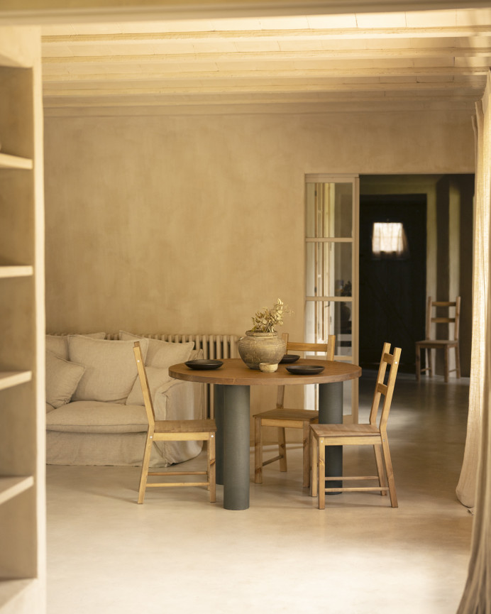 Round solid oak wood dining table with dark oak tone and microcement legs in various sizes.