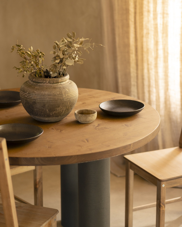 Round solid oak wood dining table with dark oak tone and microcement legs in various sizes.