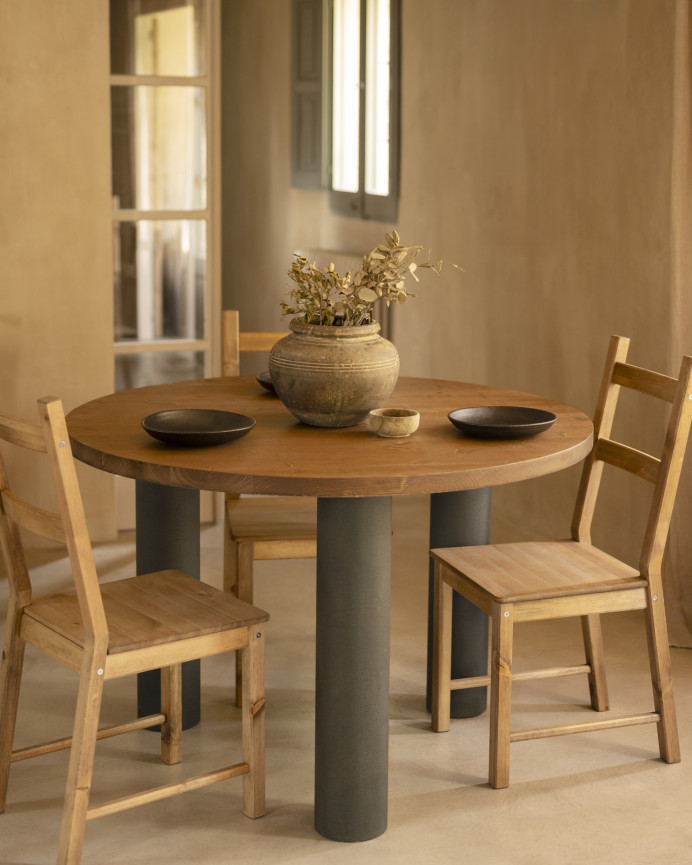 Round solid oak wood dining table with dark oak tone and microcement legs in various sizes.