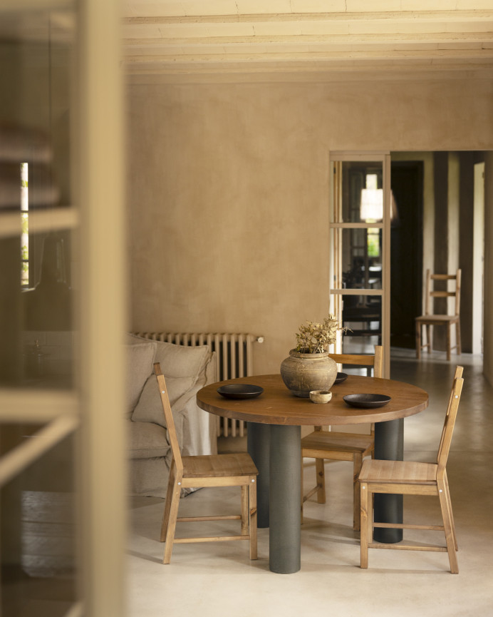 Round solid oak wood dining table with dark oak tone and microcement legs in various sizes.