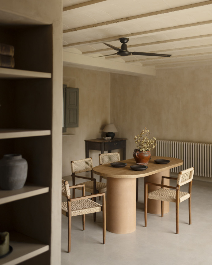 Oval solid wood dining table in medium oak tone with terracotta microcement legs in various sizes.