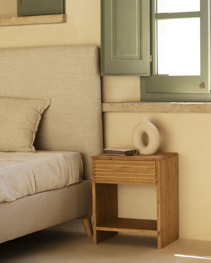 Solid wood bedside table with a drawer in a medium oak tone of various sizes.
