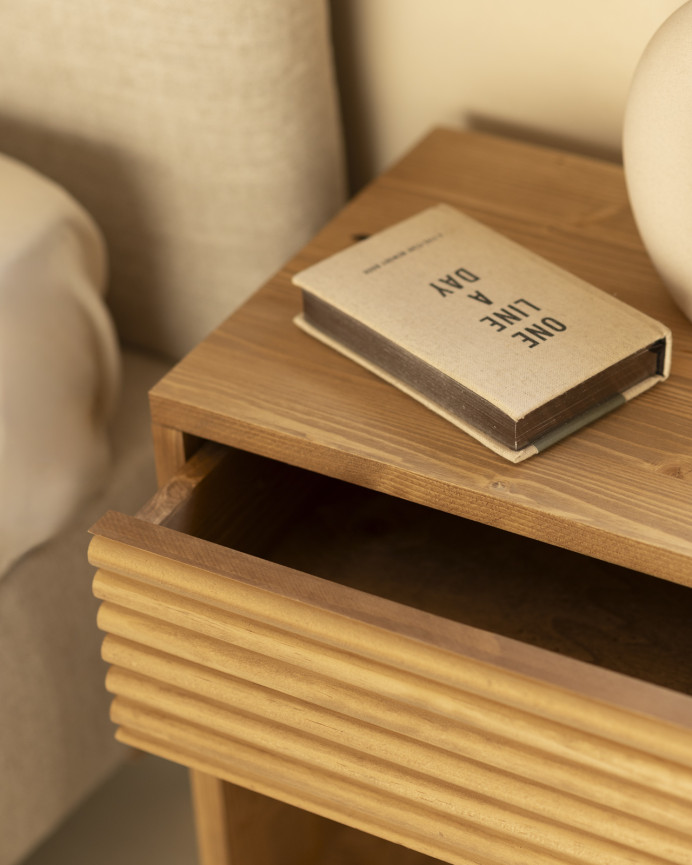 Solid wood bedside table with a drawer in a medium oak tone of various sizes.
