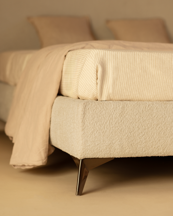 Upholstered light gray bouclé base for mattress of various sizes.