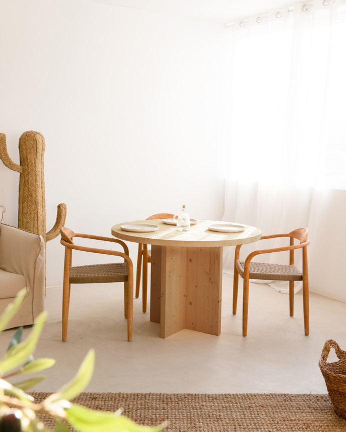 Solid wood round dining table in medium oak tone with a diameter of 110cm