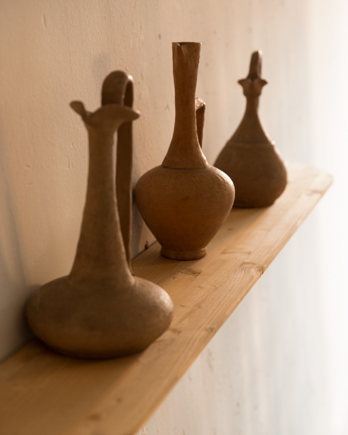 Rounded solid wood floating shelf in medium oak tone, various sizes.