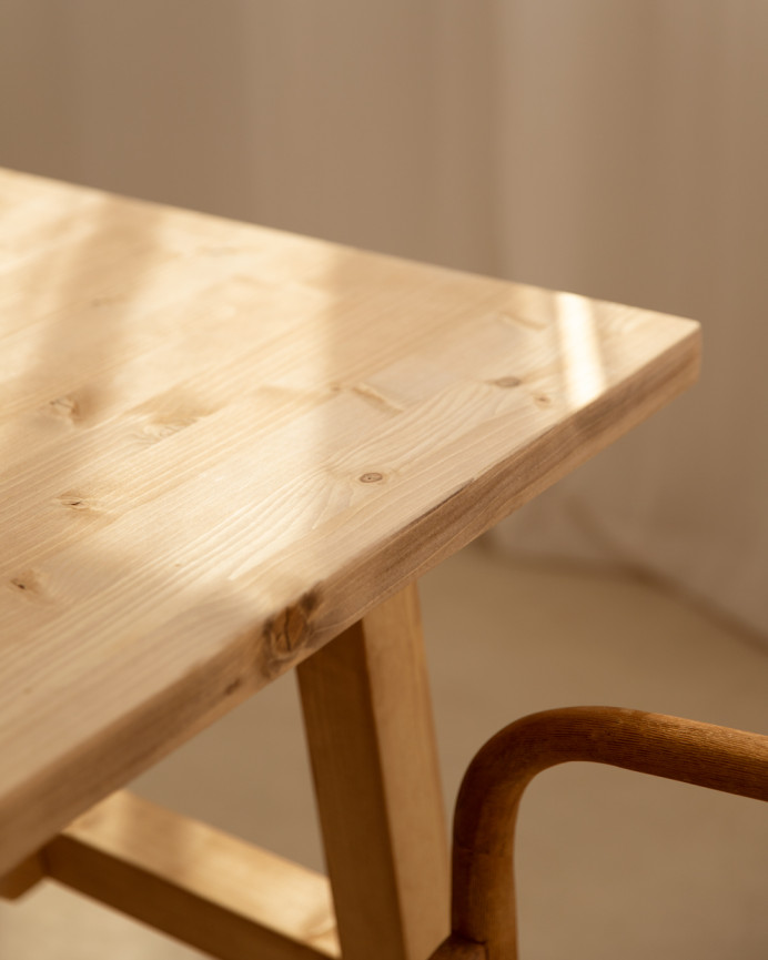 Solid wood dining table in a medium oak tone available in various sizes.