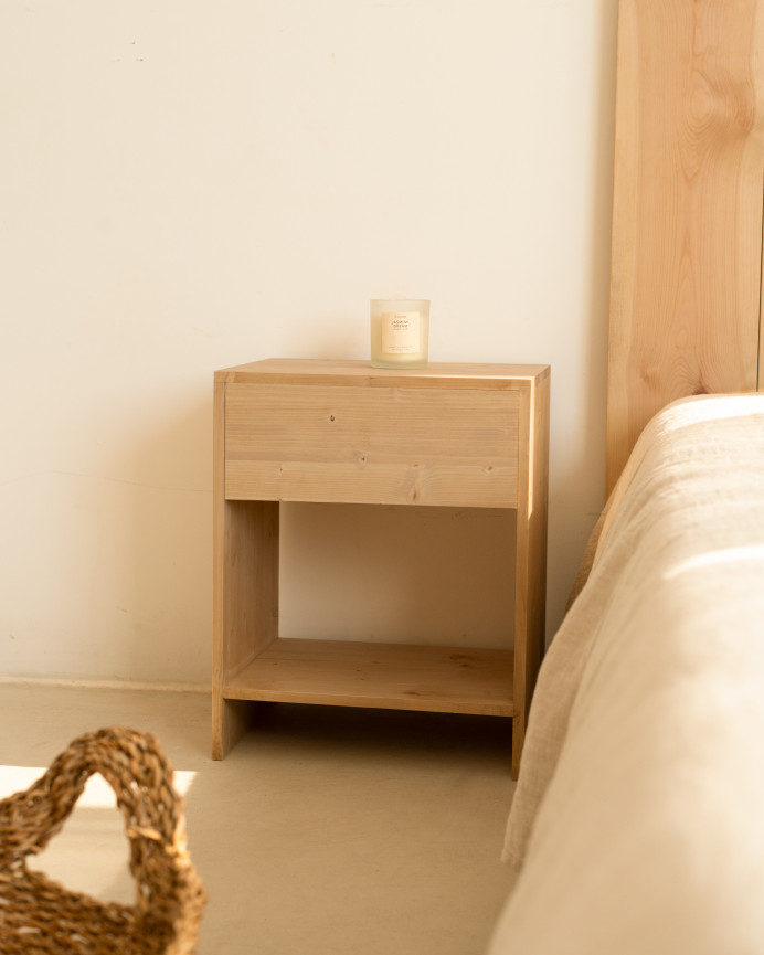 Set of 2 solid wood side tables with a drawer in a medium oak tone in various sizes.